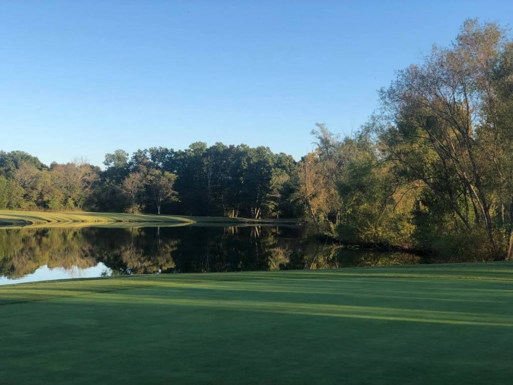 Golf course green with pond